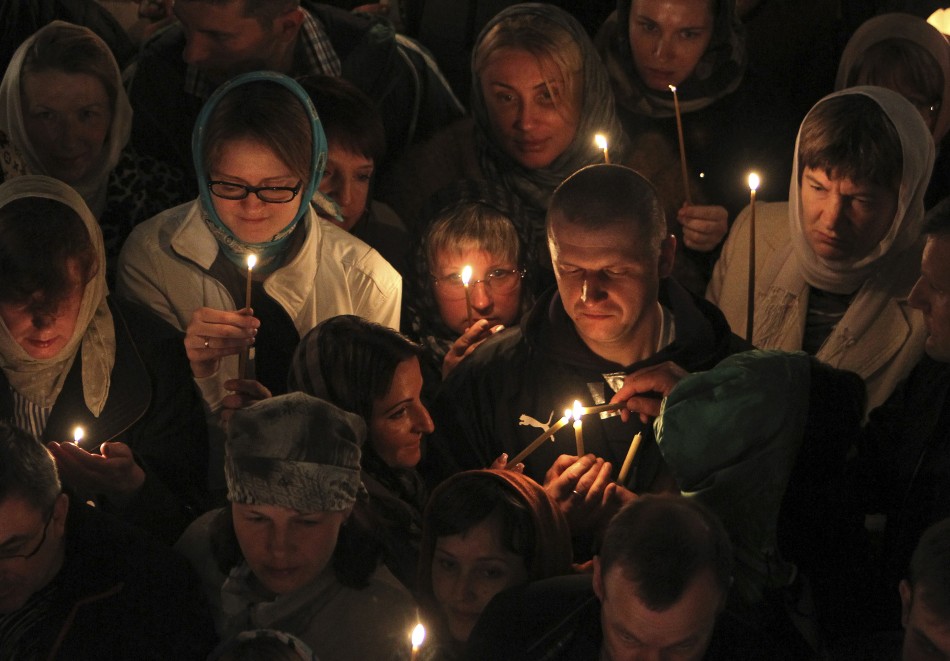 Russian Christian Orthodox worshippers light candles as they wait for a holy Easter service at the Church of St. Peter and Paul in Karlovy Vary May 5, 2013. The spa town of Karlovy Vary has a large number of Russian residents and is also a popular tourist