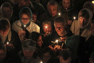 Russian Christian Orthodox worshippers light candles as they wait for a holy Easter service at the Church of St. Peter and Paul in Karlovy Vary May 5, 2013. The spa town of Karlovy Vary has a large number of Russian residents and is also a popular tourist