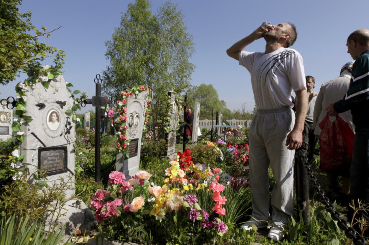 A man drinks vodka at a grave during Orthodox Easter in the village of Pogost, some 250 km (155 miles) south of Minsk May 5, 2013. Villagers in southern parts of Belarus visit their relatives' graves during Easter celebrations on Sunday.