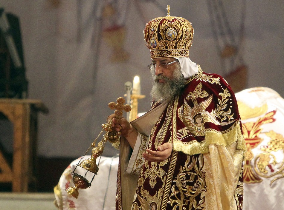 Coptic Pope Tawadros II, head of the Coptic Orthodox church, carries a censer of burning incense as he takes part in a ritual as part of a Coptic Orthodox Easter mass at the main cathedral in Cairo May 4, 2013.