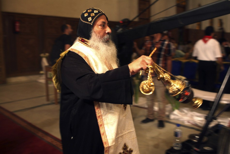 A priest uses incense as he takes part in a ritual as part of a Coptic Orthodox Easter mass at the main cathedral in Cairo May 4, 2013.
