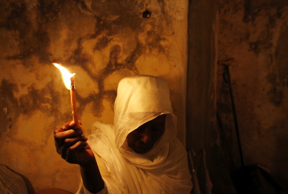 An Ethiopian Orthodox worshipper holds a candle during the Holy Fire ceremony at the Ethiopian section of the Church of the Holy Sepulchre in Jerusalems Old City May 4, 2013.