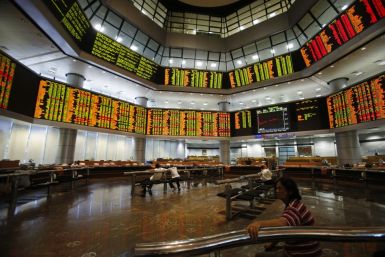 Investors monitor stock market prices in Kuala Lumpur May 6, 2013. Malaysian stocks surged nearly 8 percent to a record high and the local currency jumped to its strongest in 20 months on Monday after the Barisan National (BN) coalition extended its 56-ye