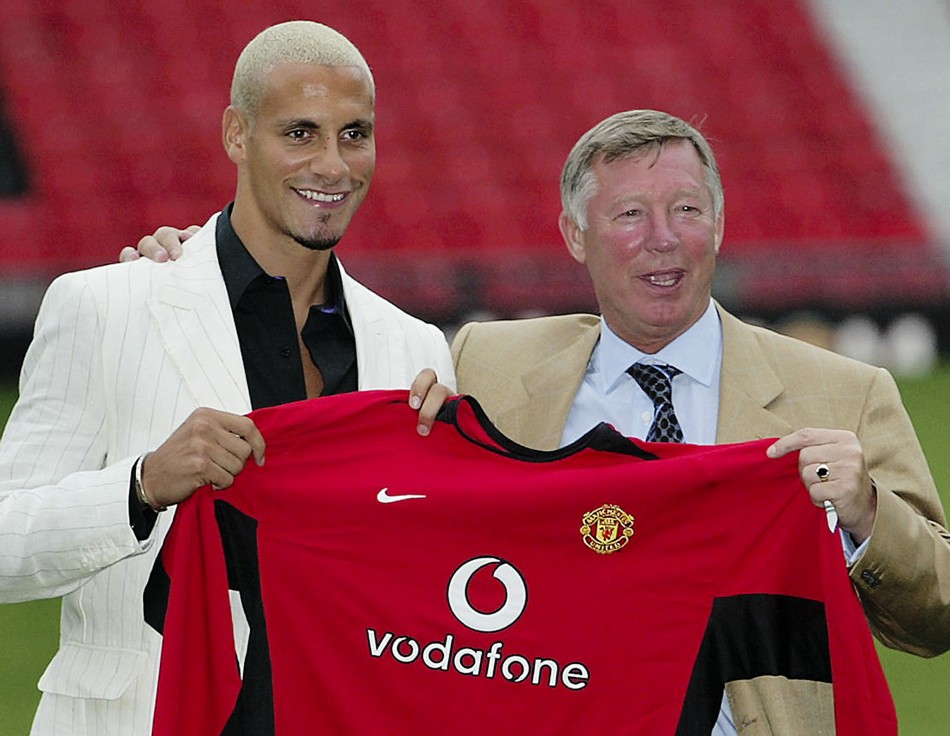 July 22 2002 Uniteds new signing Rio Ferdinand holds up his shirt with Ferguson at Old Trafford. United signed the centre-back for a then-British record of 30 million 47.27 million from Leeds United.
