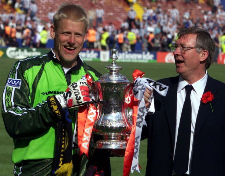 Peter Schmeichel holds the FA Cup with manager Alex Ferguson after defeating Newcastle United 2-0 in 1999 (Reuters)