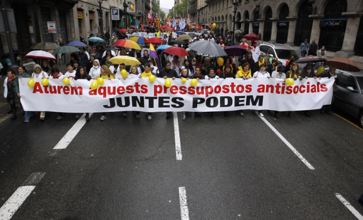 People hold banners as they march during a protest against government austerity measures in Barcelona April 28, 2013. The banner reads "Let's stop this anti-social budget. Together it's possible". (Photo: Reuters)