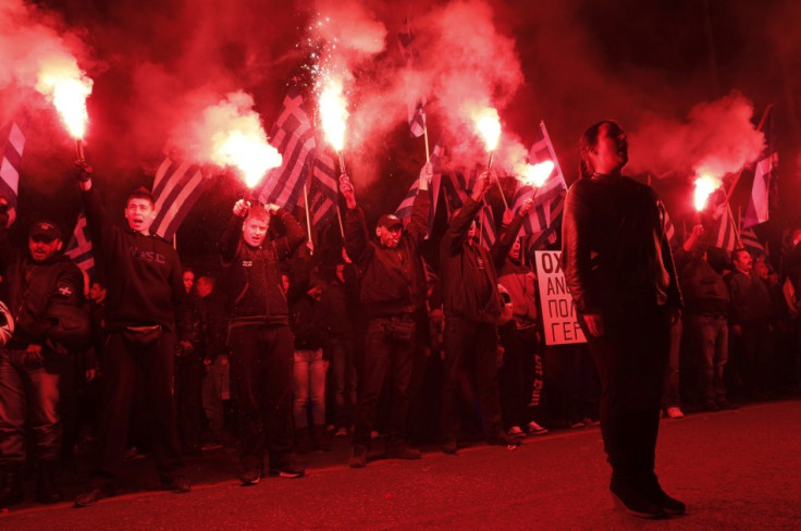 Supporters of the extreme-right Golden Dawn party hold flares as they chant the national anthem, during a rally over the crisis in Cyprus, outside the German embassy in Athens March 22, 2013. Cyprus was just hours away from a deal on Friday to raise billi