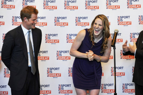 Britain's Prince Harry (L), and British Ambassador Peter Westmacott (R), celebrate the 18th birthday of Olympic gold medal swimmer Missy Franklin during a reception at the Sanctuary Golf Course in Sedalia, Colorado May 10, 2013.