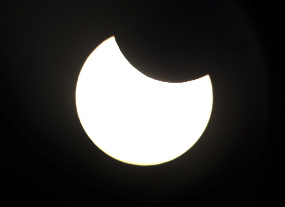 The annular solar eclipse can be seen through the viewfinder of a telescope positioned atop Observatory Hill in Sydney May 10, 2013.