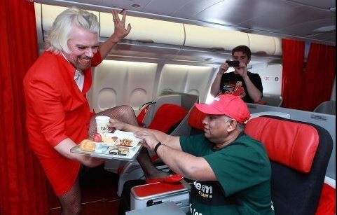 Richard Branson dresses as airline stewardess after losing F1 bet