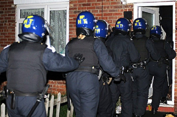 police break down door during raid