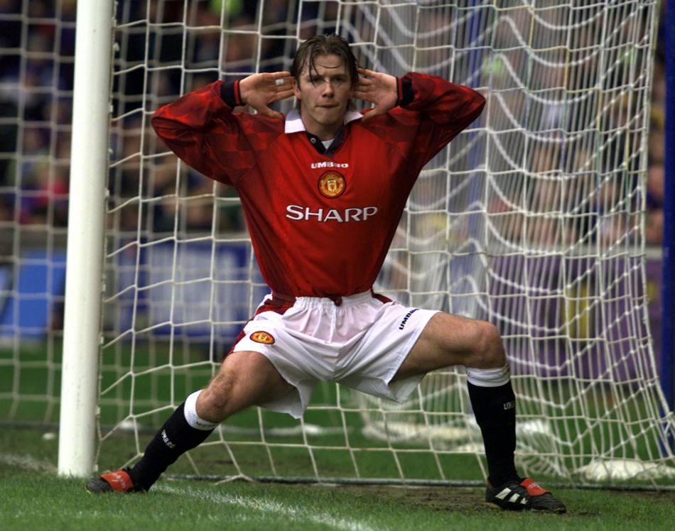Manchester Uniteds David Beckham encourages the crowd to cheer after he scored the opening goal against Chelsea during their match at Stamford Bridge January 4 1998.