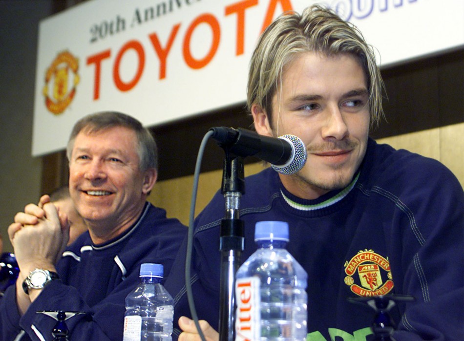 David Beckham speaking to reporters with Manchester Uniteds head coach Alex Ferguson during a news conference following their arrival in Tokyo November 27 1999.
