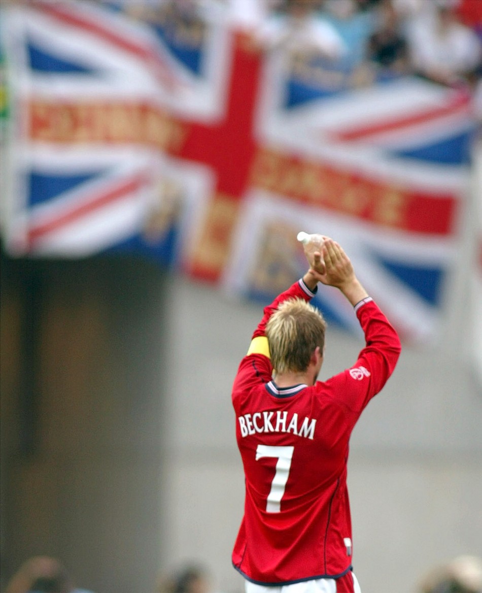 David Beckham acknowledges supporters as he walks off the pitch after the World Cup Finals group F match against Nigeria in Osaka June 12, 2002.
