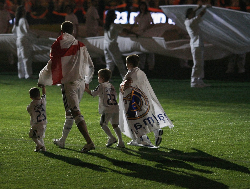 David Beckham walks away with his sons, Cruz L, Romeo and Brooklyn R, after their Spanish First Division soccer match victory over Real Mallorca at the Santiago Bernabeu stadium in Madrid June 17, 2007.