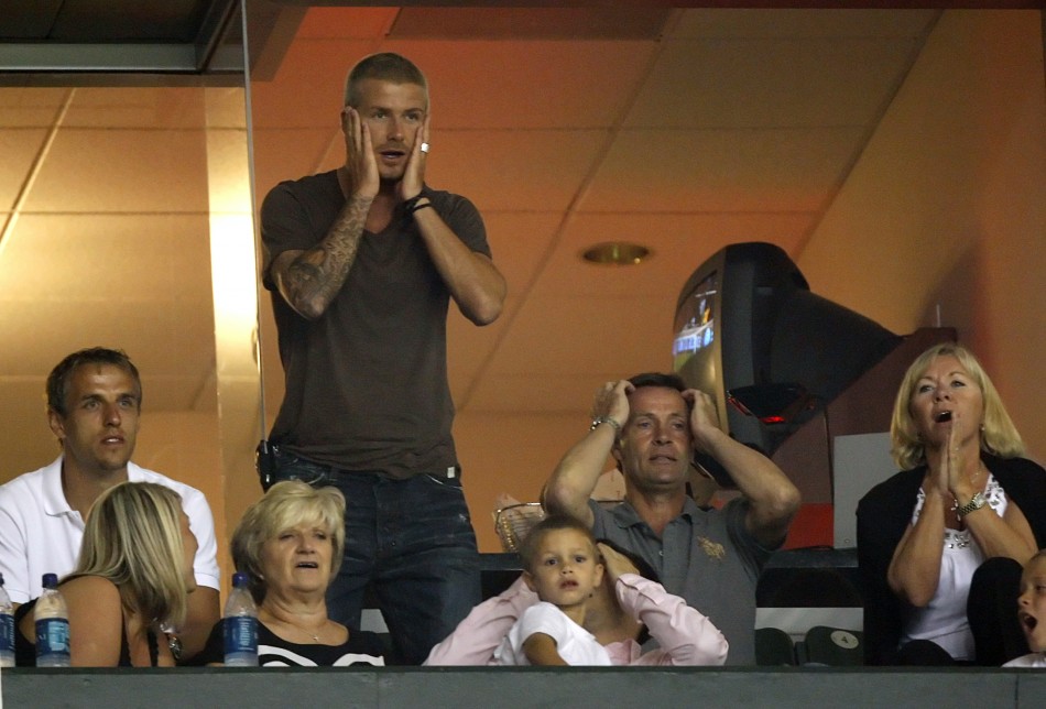 David Beckham standing reacts as his team misses a scoring chance while watching the team play their SuperLiga tournament friendly match against CF Pachuca from a private box in Carson, California July 24, 2007.