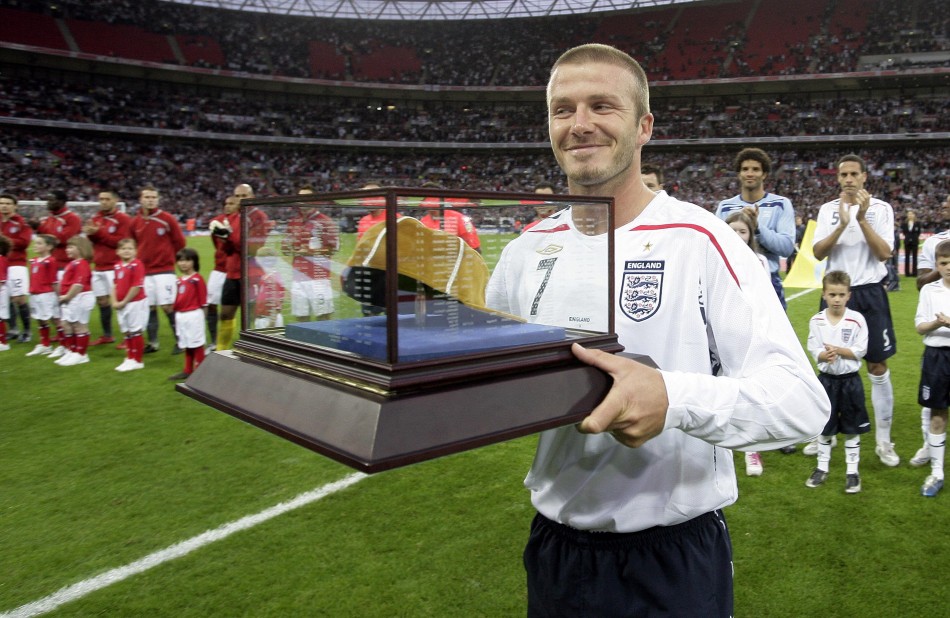 David Beckham smiles after receiving his 100th cap before the teams international friendly soccer match against the U.S. at Wembley Stadium in London May 28, 2008.