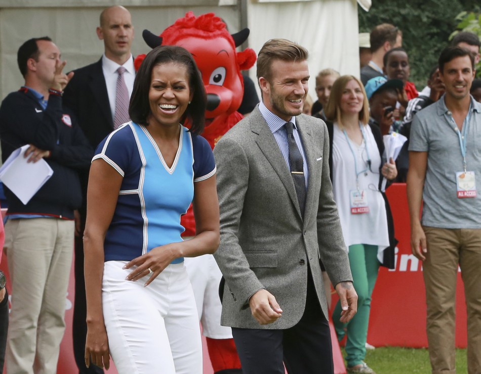 U.S. first lady Michelle Obama stands next to British footballer David Beckham during an event at the U.S. embassy in central London July 27, 2012.