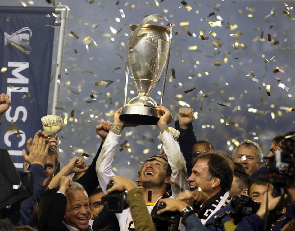 David Beckham hoists the championship trophy as the team celebrate their victory over the Houston Dynamo during their MLS Cup soccer final match in Carson, California, November 20, 2011.