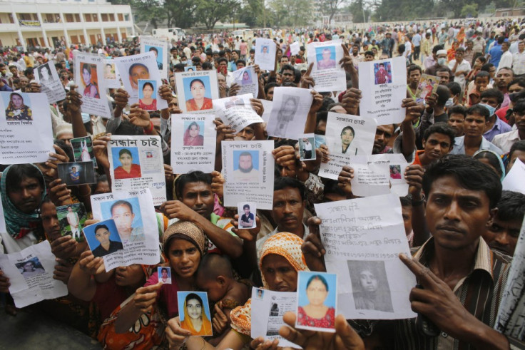 Relatives mourn as they show pictures of garment workers, who are believed to be trapped under the rubble of the collapsed Rana Plaza building, in Savar, 30 km (19 miles) outside Dhaka April 28, 2013. (Photo: Reuters)