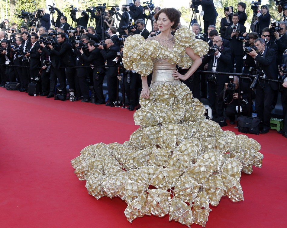 A guest poses on the red carpet as she arrives for the screening of the film Le Passe The Past in competition during the 66th Cannes Film Festival in Cannes May 17, 2013.