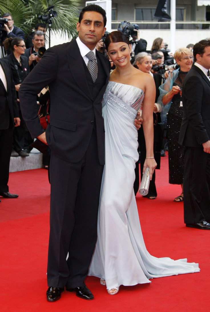 Bollywood actress Aishwarya Rai Bachchan (R) and actor Abhishek Bachchan pose on the red carpet as they arrive for the screening of the film "Chun feng chen zui de ye wan" (Spring Fever), at the 62nd Cannes Film Festival May 14, 2009.