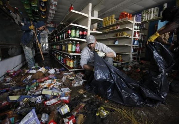 Soldier helps clean up damage at one business during Hurricane Sandy (Photo: Reuters)