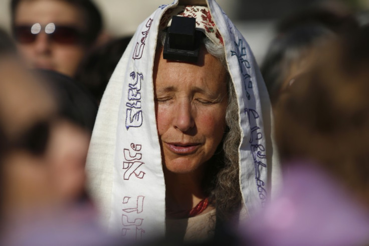 A member of "Women of the Wall" group wears a prayer shawl and Tefillin