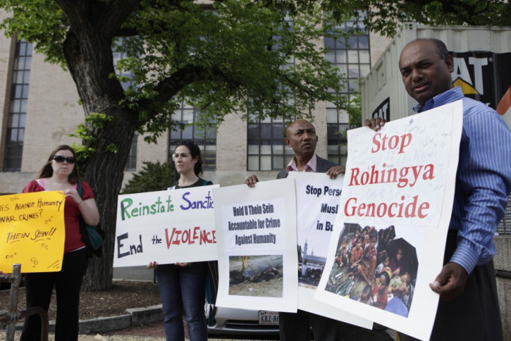 Protesters rally outside the Voice of America headquarters building before the arrival of Myanmar President Thein Sein