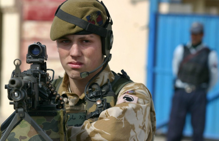 Young British soldier with Afghan officer behind him