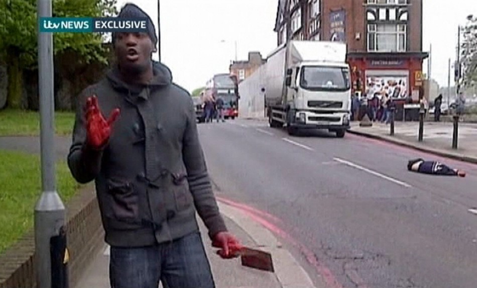 A man with bloodied hands and knives appears in a still image from amateur video that shows the immediate aftermath of an attack in which a man was killed in southeast London (Reuters)