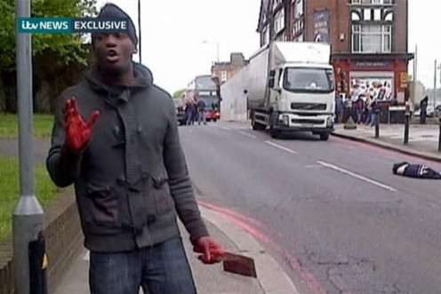 A man with bloodied hands and knives appears in a still image from amateur video that shows the immediate aftermath of an attack in which a man was killed in southeast London (Reuters)