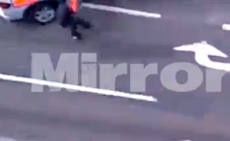Michael Adebolajo reels away from police car after being hit