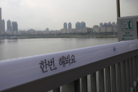 An SOS telephone booth and message of support for those contemplating suicide on a Seoul bridge.