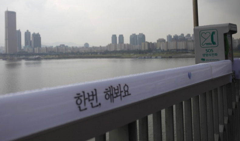 An SOS telephone booth and message of support for those contemplating suicide on a Seoul bridge.
