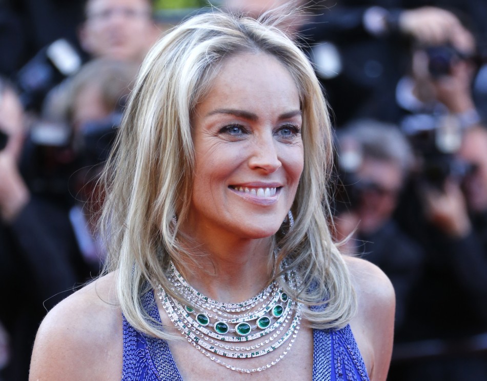 Actress Sharon Stone poses on the red carpet as she arrives for the screening of the film Behind the Candelabra in competition during the 66th Cannes Film Festival in Cannes May 21, 2013.
