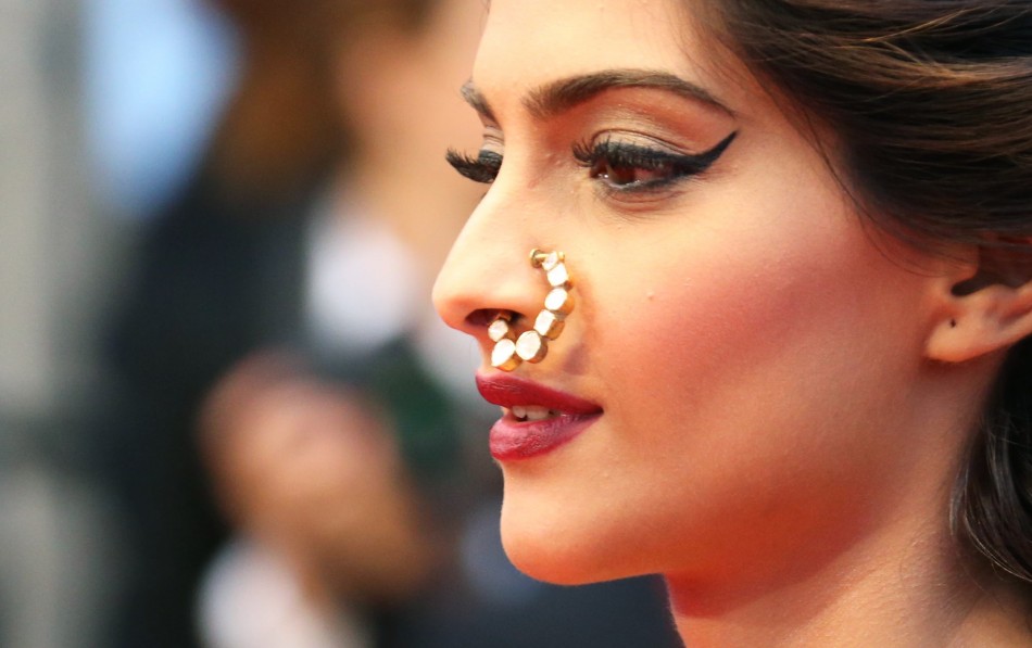 Bollywood actress Sonam Kapoor poses on the red carpet as she arrives for the screening of the film The Great Gatsby and for the opening ceremony of the 66th Cannes Film Festival in Cannes May 15, 2013.