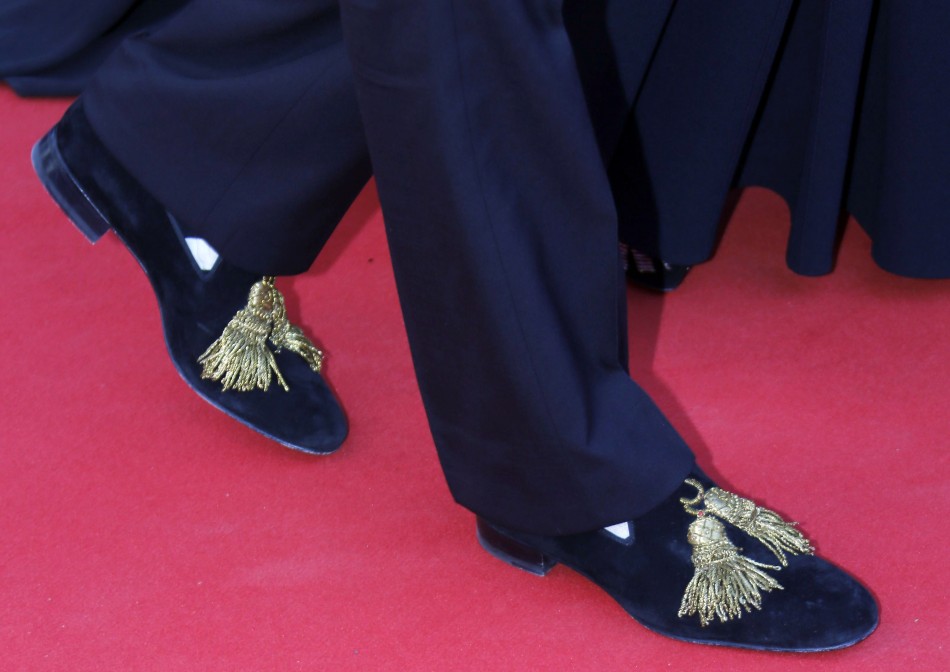The shoes of French designer Christian Louboutin are pictured as he poses on the red carpet for the screening of the film Le Passe The Past in competition during the 66th Cannes Film Festival in Cannes May 17, 2013.