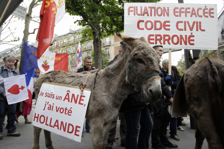 'Iam an ass, I voted for Hollande', reads the caption on the protester's donkey.