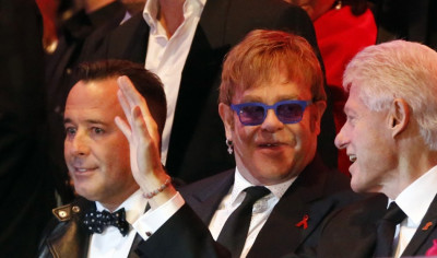 British singer Elton John C and his partner David Furnish L listen to former U.S. President Bill Clinton R during the opening ceremony of the 21st Life Ball in Vienna British singer Elton John C and his partner David Furnish L listen to former U.S. President Bill Clinton R during the opening ceremony of the 21st Life Ball in Vienna