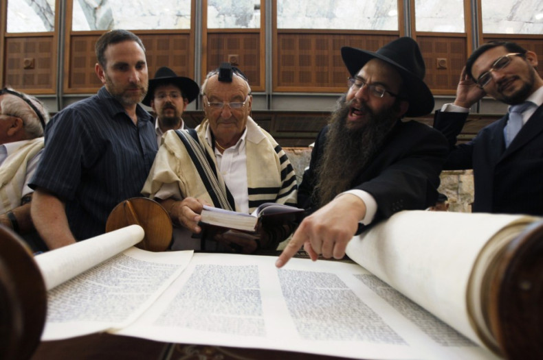 Holocaust survivor Israel Levin (3rd R) reads from a Torah scroll during his Bar Mitzvah ceremony at the Western Wall