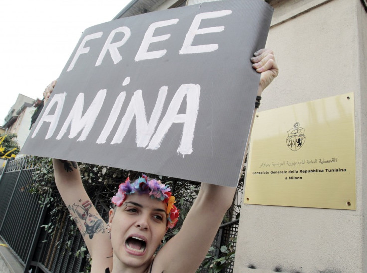 An activist from women's rights group Femen takes part in a protest in front of the Consulate General of the Tunisian Republic in Milan