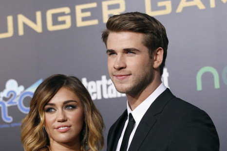 Liam Hemsworth poses with actress Miley Cyrus