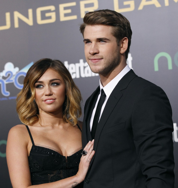 Liam Hemsworth poses with actress Miley Cyrus