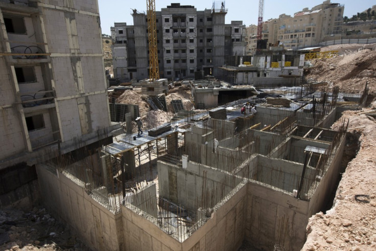 Labourers work on a construction site in a Jewish settlement near Jerusalem