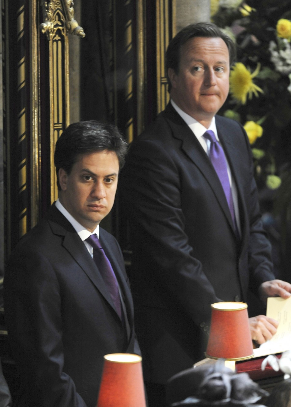 Prime Minister David Cameron R and opposition Labour Party leader Ed Miliband attend a service celebrating the 60th anniversary of Queen Elizabeths coronation at Westminster Abbey in London June 4, 2013.