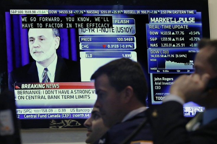 Traders work as a press conference by Federal Reserve Chairman Ben Bernanke is seen on a television on the floor of the New York Stock Exchange (Photo: Reuters)