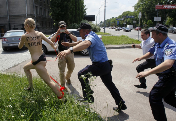 Interior ministry officers and security chase Femen activist in Kiev