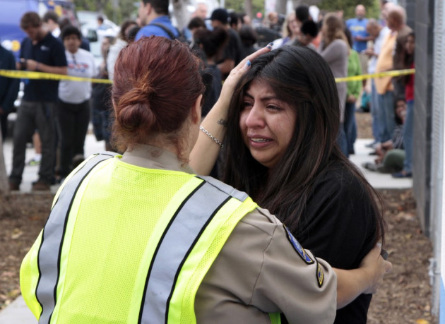 A women is comforted by a traffic officer near Santa Monica College following a shooting on the campus in Santa Monica. A women is comforted by a traffic officer near Santa Monica College following a shooting on the campus in Santa Monica.
