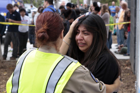 A women is comforted by a traffic officer near Santa Monica College following a shooting on the campus in Santa Monica.